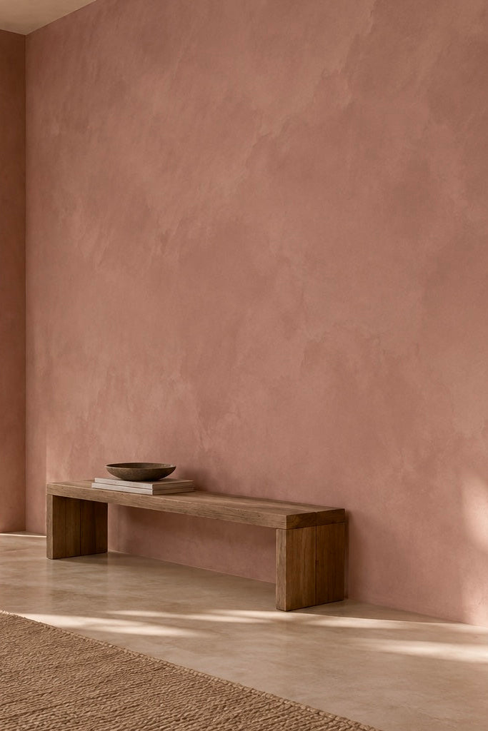Minimal interior decoration with earthy red limewash walls by limewash.com