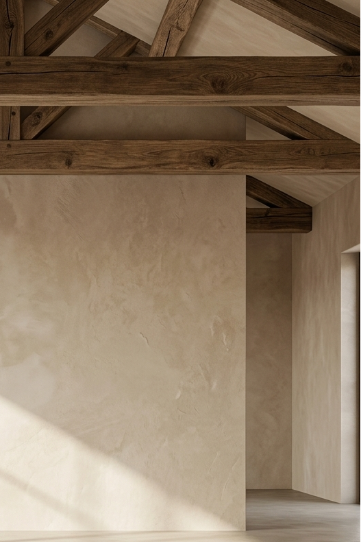 Beige room with wooden beams and a textured wall.