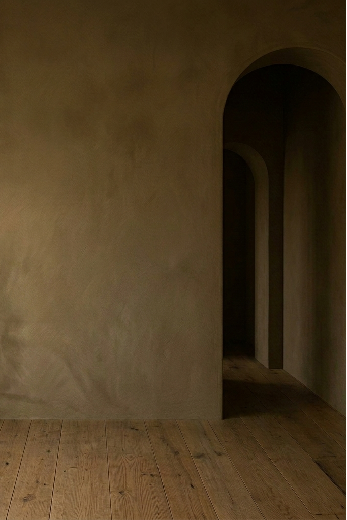 Dark room with limewash walls and wooden floor